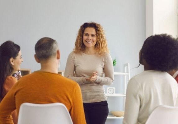 coach speaking durning a group coaching session