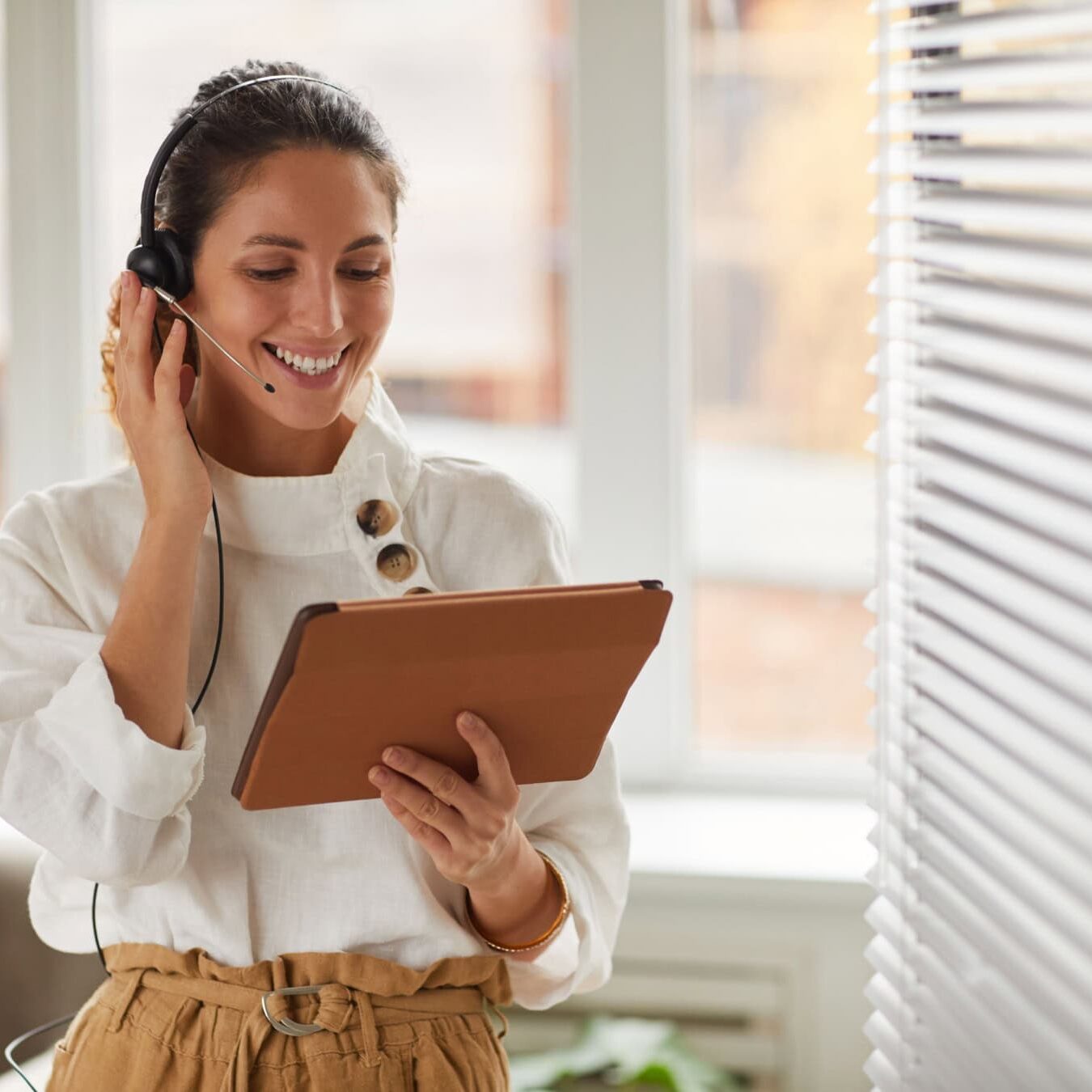 A woman is reviewing her ICF membership renewal through her tablet