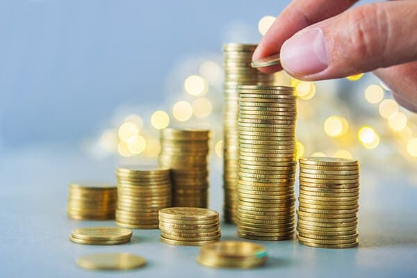 stacking gold coins on a table