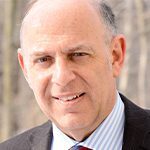 Andre Politzer headshot photo, smiling man wearing suit outside