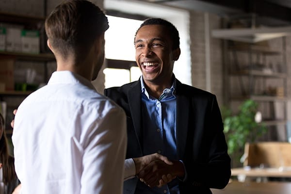two men meeting and shaking hands